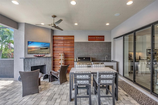 view of patio featuring sink, a grill, and ceiling fan