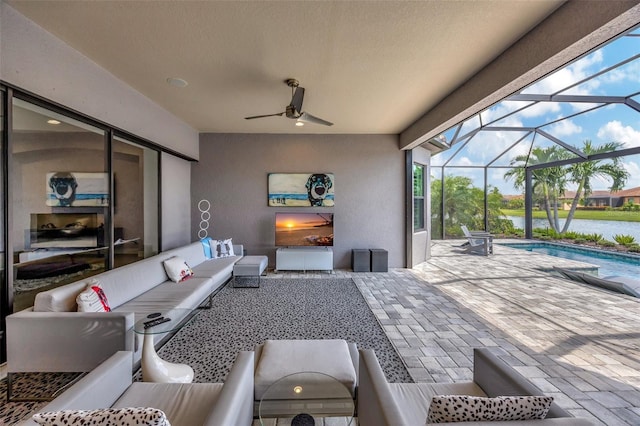 view of patio / terrace featuring glass enclosure, ceiling fan, and an outdoor hangout area