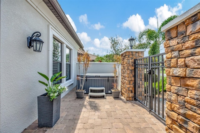 view of patio / terrace featuring a hot tub