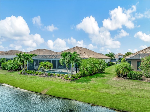 rear view of house with a water view, a lanai, a yard, and a pool