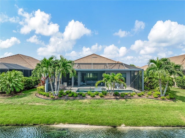 rear view of house featuring glass enclosure, a yard, a swimming pool, a patio area, and a water view