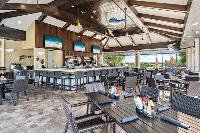 dining area with beamed ceiling, high vaulted ceiling, and wooden ceiling