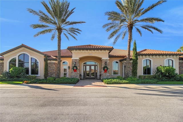 mediterranean / spanish-style house featuring french doors