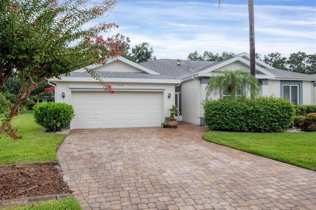 single story home with a front yard and a garage