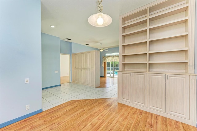 tiled empty room featuring ceiling fan