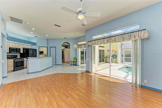 kitchen featuring black fridge with ice dispenser, light hardwood / wood-style floors, white cabinetry, ceiling fan, and stainless steel range with gas stovetop