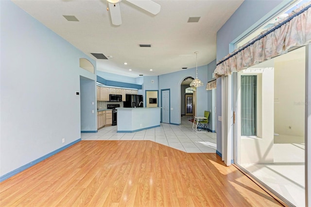 kitchen with decorative light fixtures, white cabinetry, ceiling fan, light wood-type flooring, and black appliances