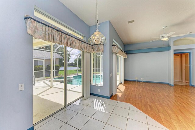 interior space with tile patterned floors and ceiling fan