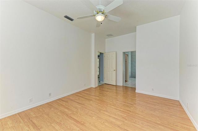 empty room with light hardwood / wood-style floors and ceiling fan