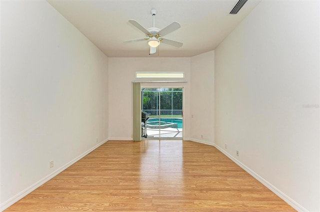 empty room featuring ceiling fan and light hardwood / wood-style floors