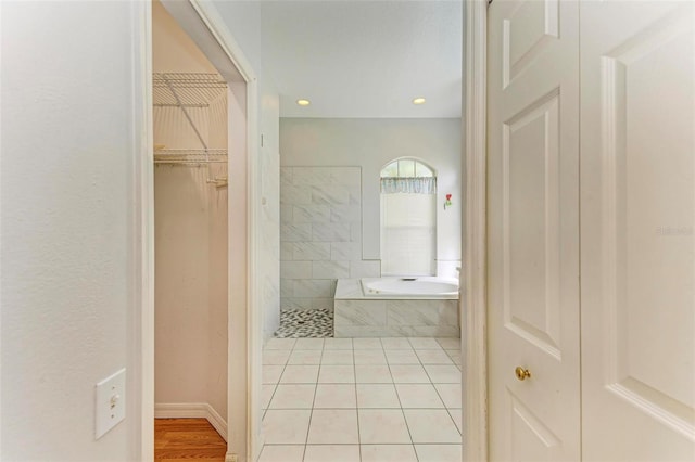 bathroom with independent shower and bath and tile patterned floors