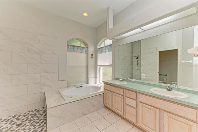 bathroom featuring tile patterned flooring, plus walk in shower, and vanity