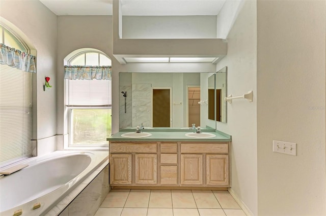 bathroom with vanity, tile patterned floors, and tiled bath