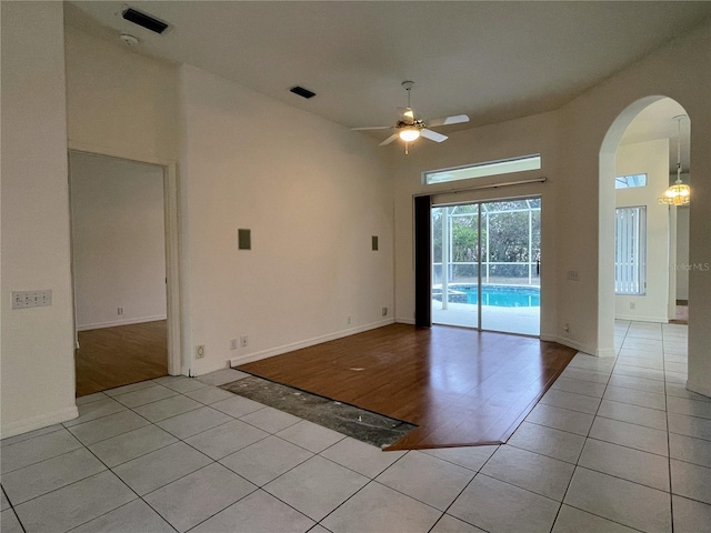 spare room featuring ceiling fan and light tile patterned floors