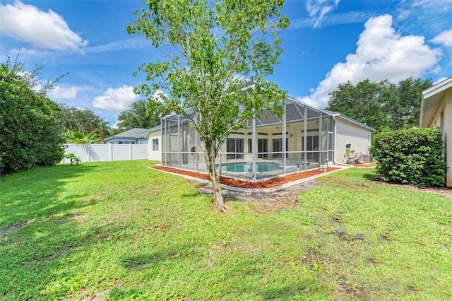 view of yard with a fenced in pool and glass enclosure