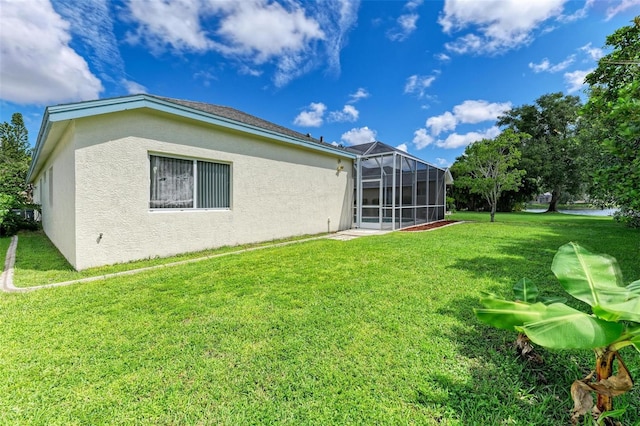 back of property with a lawn and a lanai