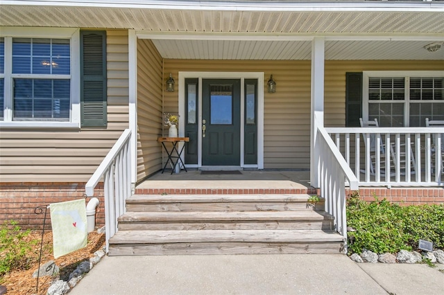 entrance to property featuring a porch