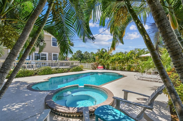 view of swimming pool featuring an in ground hot tub and a patio