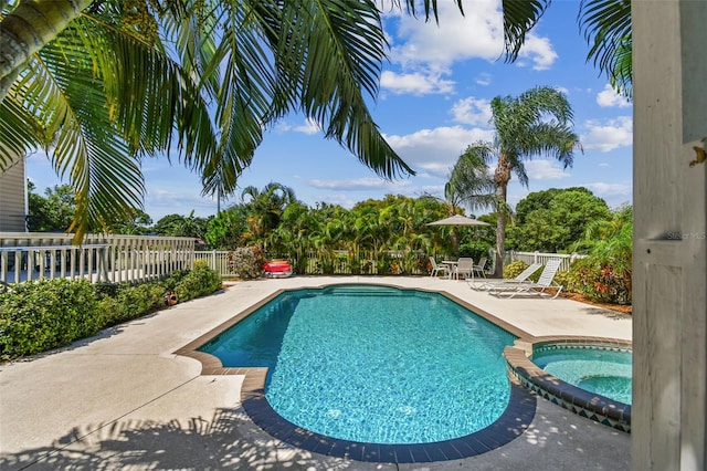 view of pool featuring an in ground hot tub and a patio