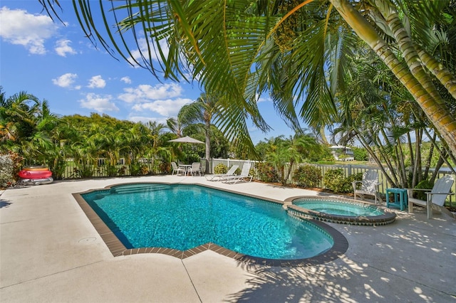 view of swimming pool with an in ground hot tub and a patio