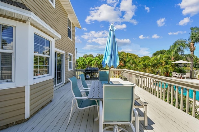 wooden deck with a pool