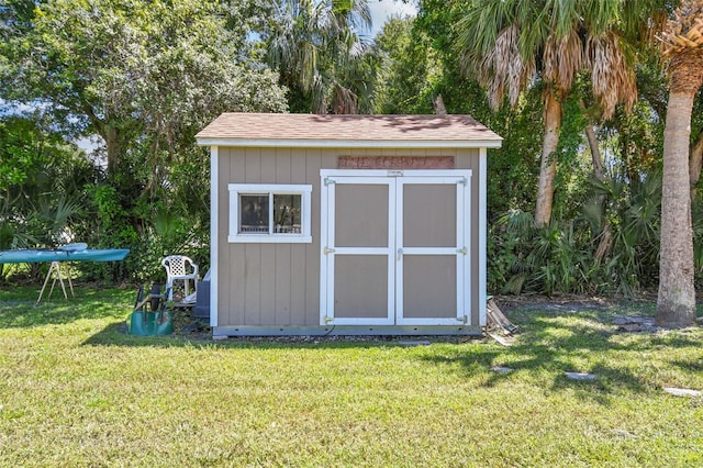 view of outbuilding with a lawn