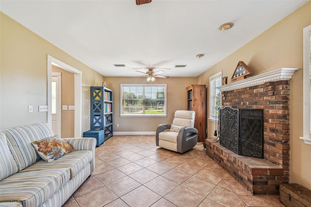 living room with a fireplace, ceiling fan, and light tile patterned flooring