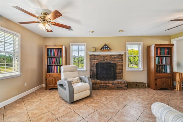 interior space with ceiling fan and a fireplace