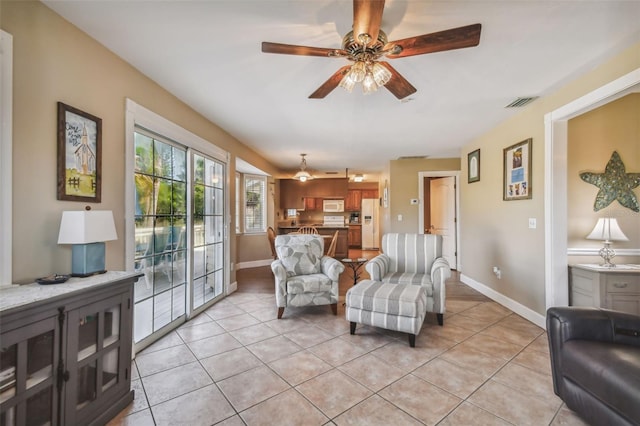 tiled living room featuring ceiling fan