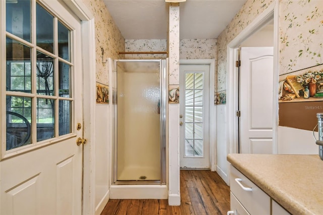 doorway with hardwood / wood-style floors and a healthy amount of sunlight