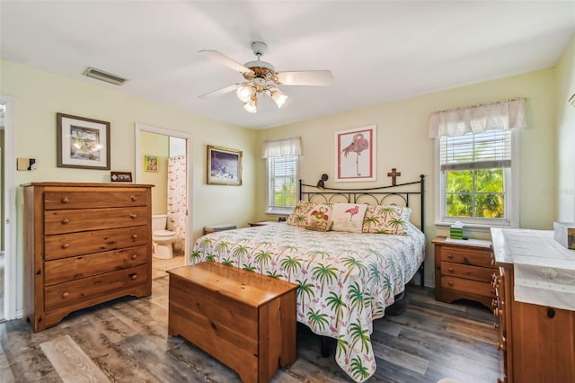 bedroom featuring hardwood / wood-style floors, ceiling fan, and ensuite bathroom