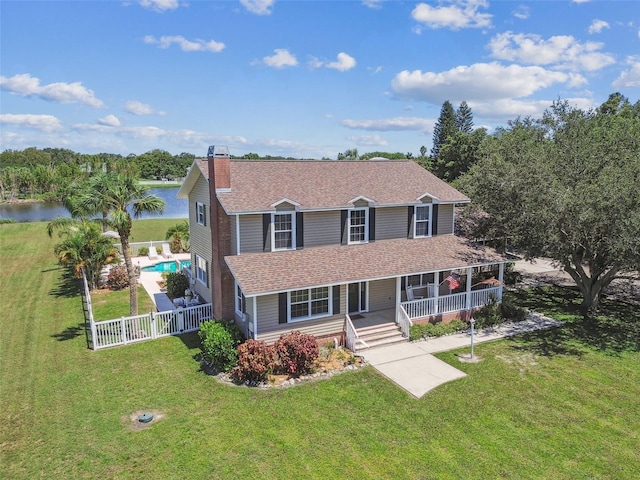 view of front of house featuring a front yard and a water view