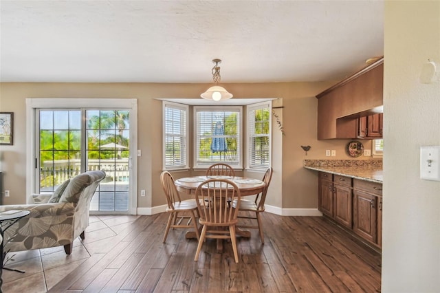 dining room with dark hardwood / wood-style flooring