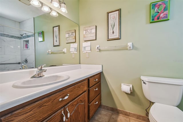 bathroom featuring toilet, tile patterned flooring, and vanity