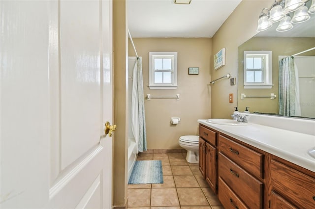 full bathroom with shower / tub combo, tile patterned floors, toilet, and vanity