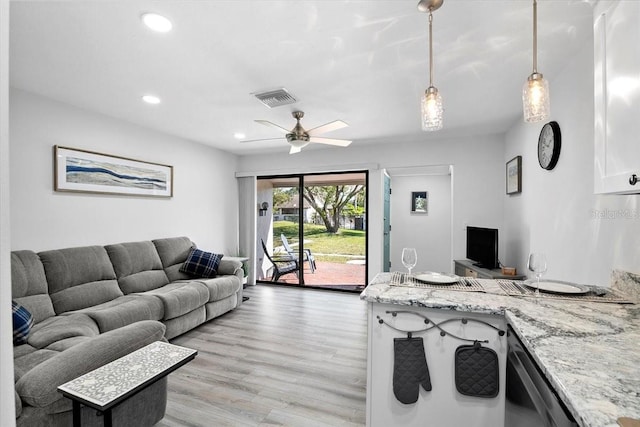 living room featuring ceiling fan and light hardwood / wood-style flooring