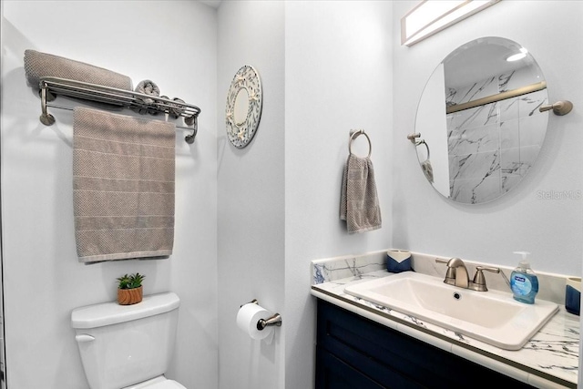 bathroom featuring vanity and toilet