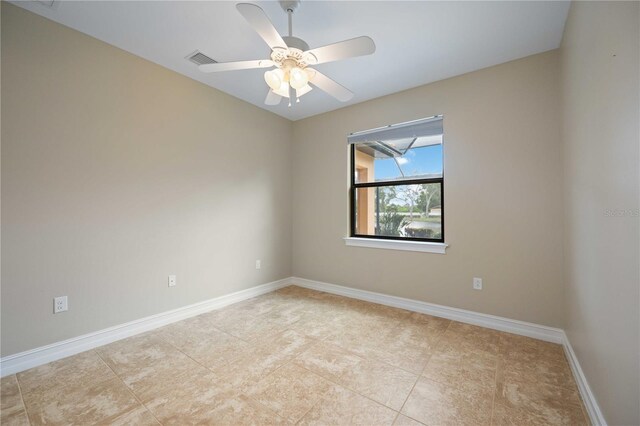 tiled spare room featuring ceiling fan