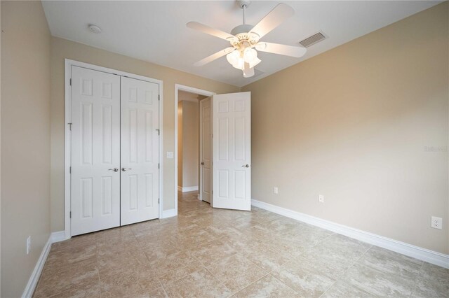 unfurnished bedroom with light tile patterned floors, a closet, and ceiling fan