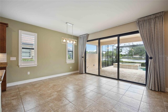 unfurnished dining area featuring a notable chandelier and light tile patterned flooring