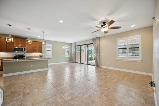 unfurnished living room with light tile patterned flooring and ceiling fan