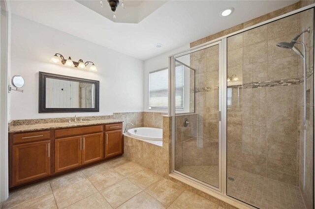 bathroom with plus walk in shower, vanity, and tile patterned floors