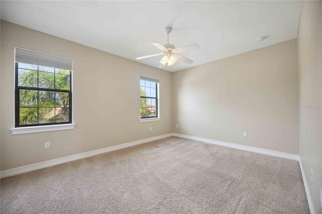 spare room featuring ceiling fan and carpet