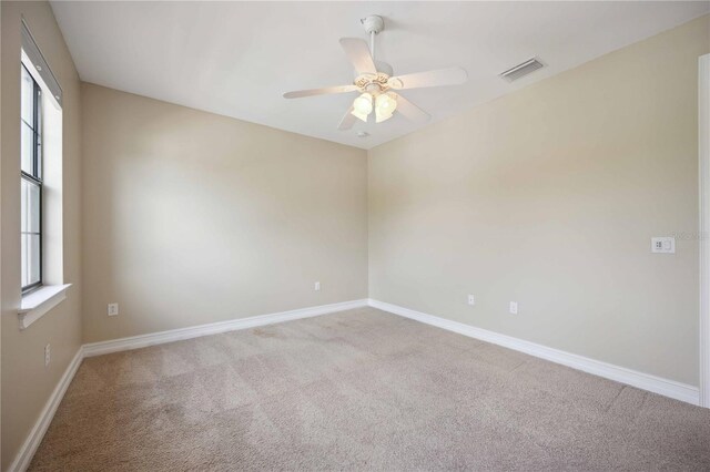 unfurnished room with carpet and ceiling fan