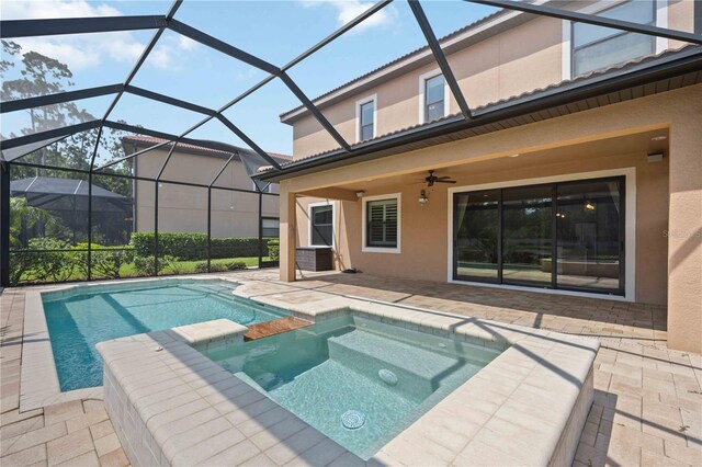 view of swimming pool with ceiling fan, a lanai, an in ground hot tub, and a patio