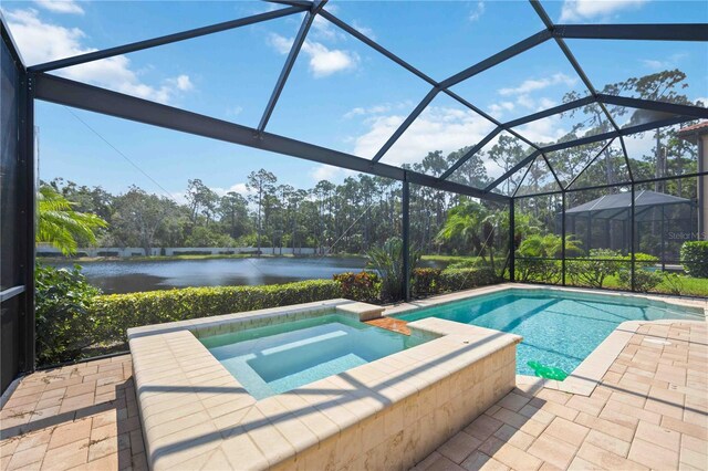 view of swimming pool featuring a water view, an in ground hot tub, a patio area, and a lanai