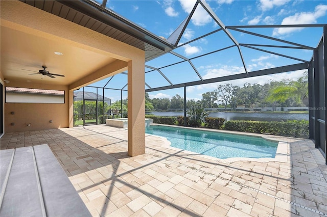 view of pool featuring a patio area, glass enclosure, and ceiling fan