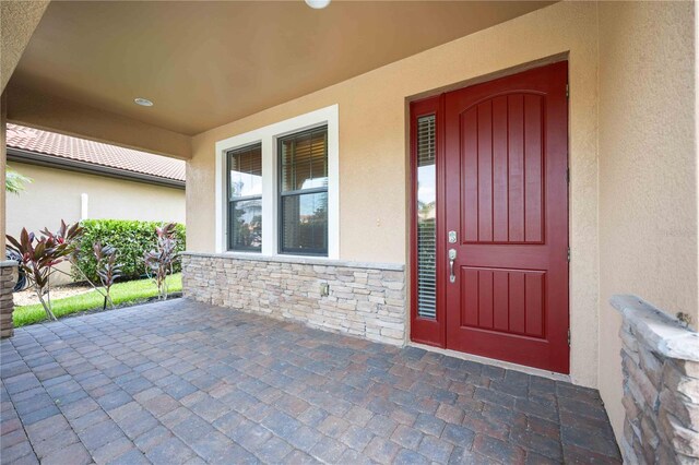 doorway to property with a patio area