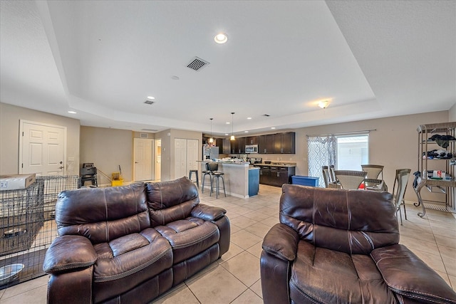 tiled living room with a raised ceiling