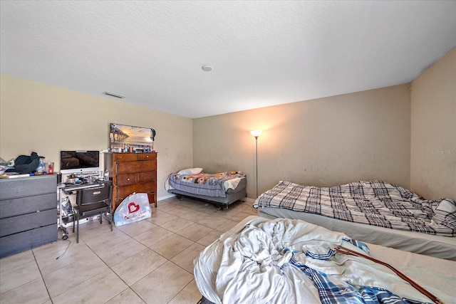 bedroom with light tile patterned floors